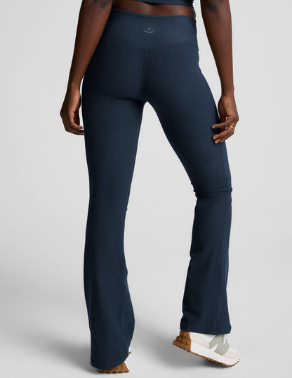 Rear view of navy Spacedye Mid-Rise Bootcut Pant with a snug fit, flared legs, and logo on the waistband.
