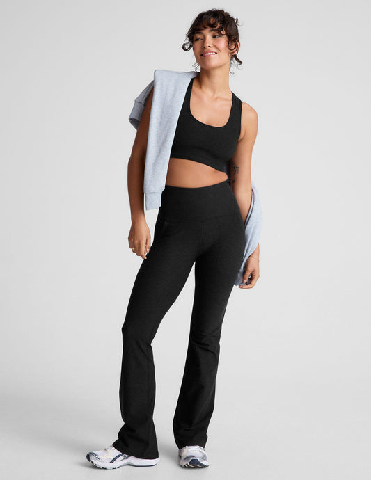 Woman in black Spacedye High Waisted Practice Pocket Bootcut Pant featuring a high waist, front pockets, and a flared leg.