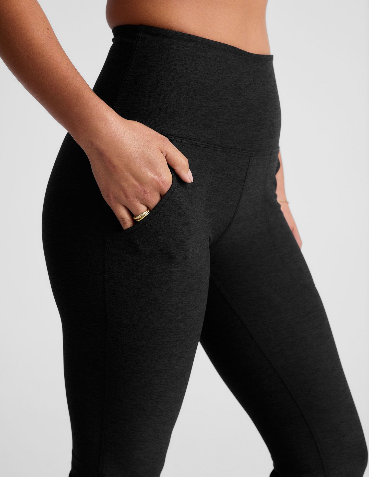 Black Spacedye High Waisted Practice Pocket Bootcut Pant featuring a high waistband and hand in the slanted hip pocket.