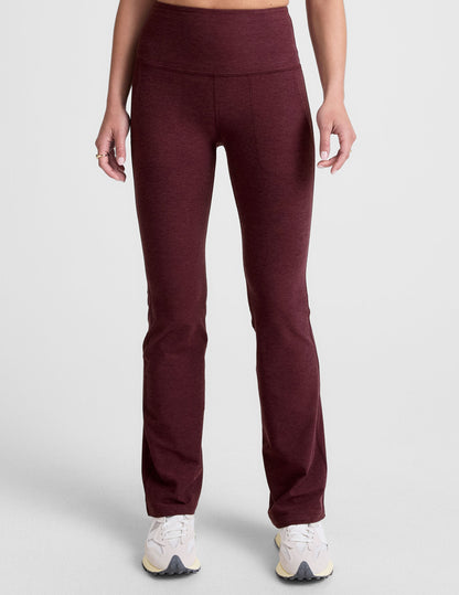 Woman wearing Maroon Spacedye High Waisted Practice Pocket Bootcut Pant™ with front pockets and white sneakers.