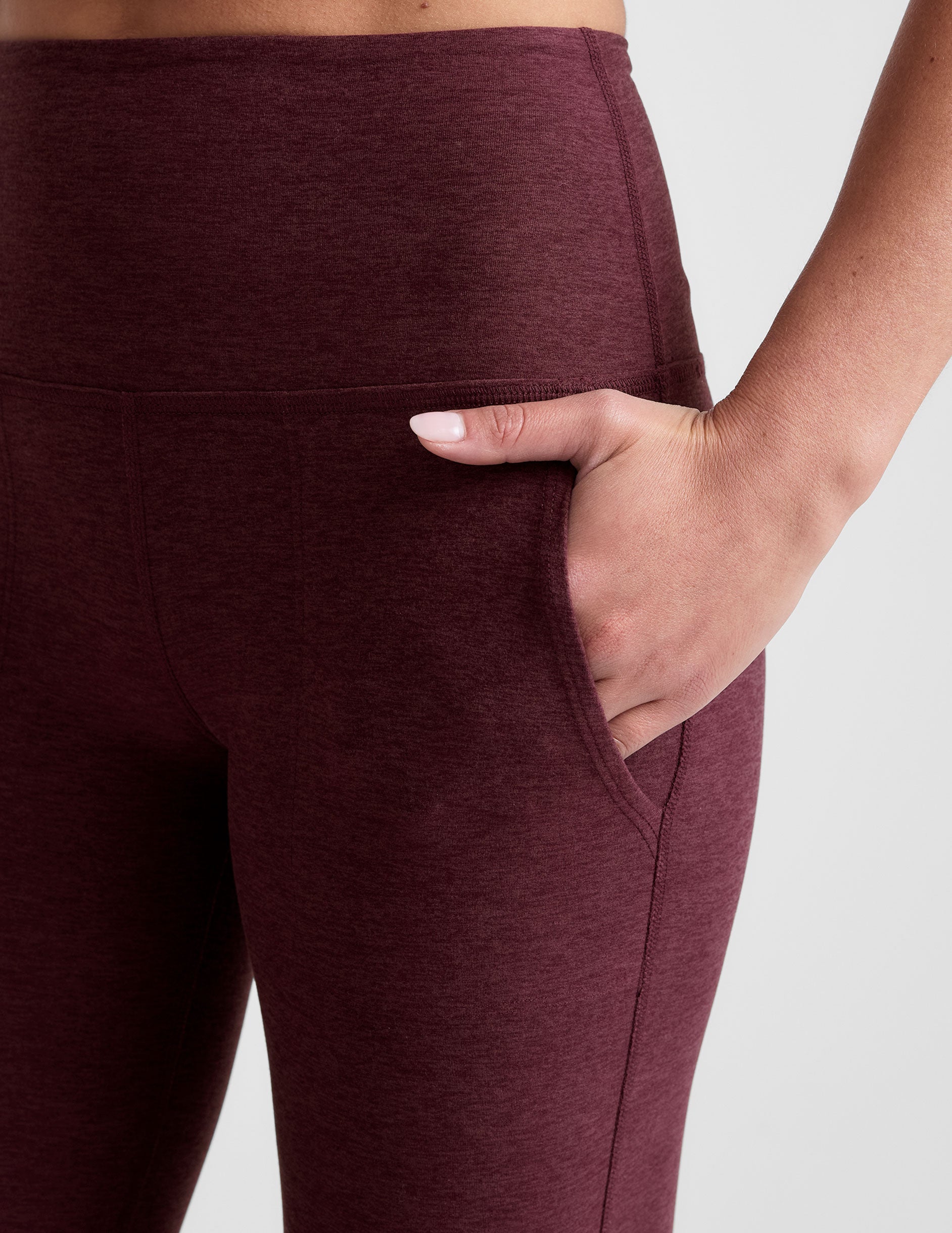 Close-up of woman with hand in slanted hip pocket of the Maroon Spacedye™ High Waisted Practice Pocket Bootcut Pant.