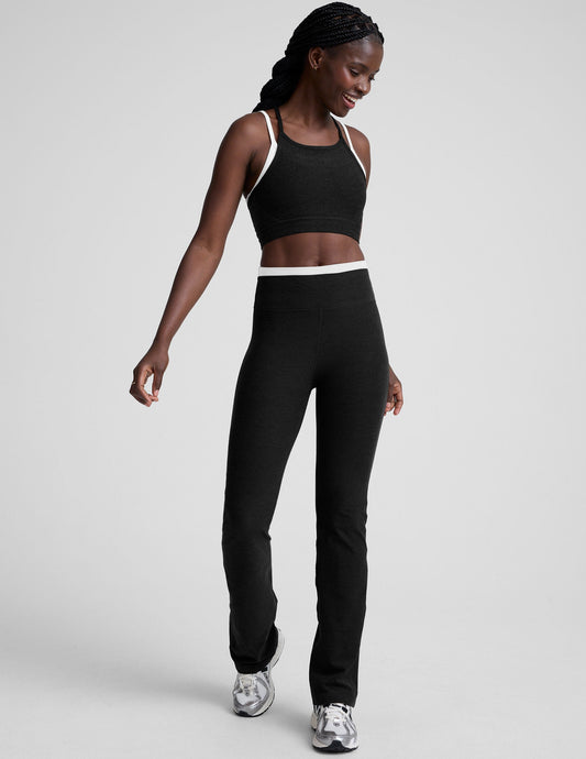 Spacedye Layered Bootcut Pant in black with a white contrast waistband, worn by a smiling model on a grey background.