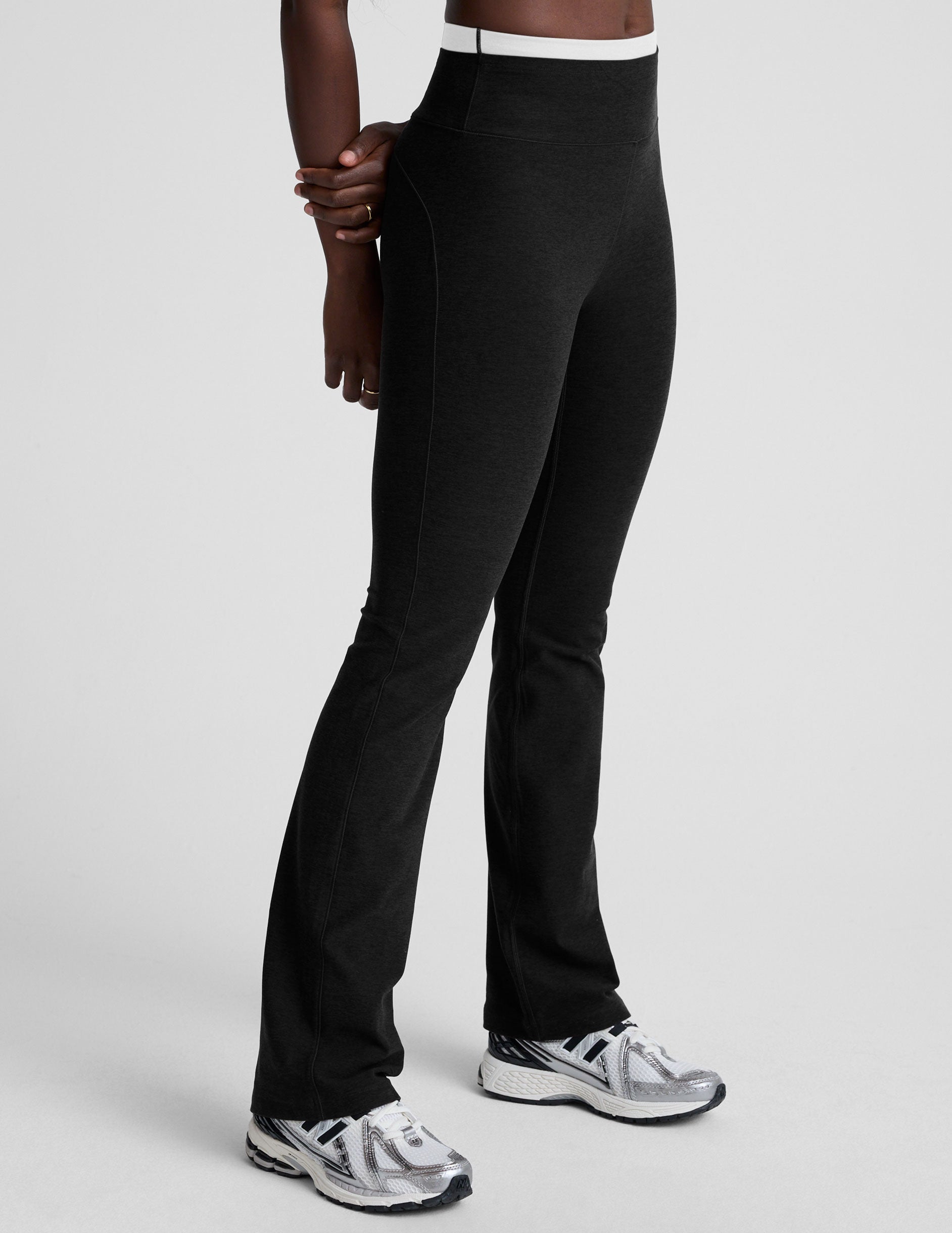 Side view of Spacedye Layered Bootcut Pant in black with a high-rise white contrast waistband and flared leg silhouette.