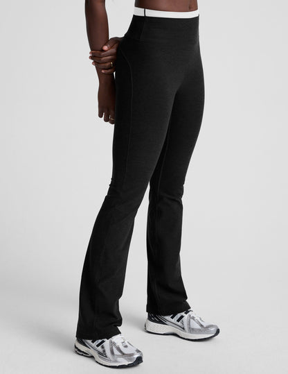 Side view of Spacedye Layered Bootcut Pant in black with a high-rise white contrast waistband and flared leg silhouette.