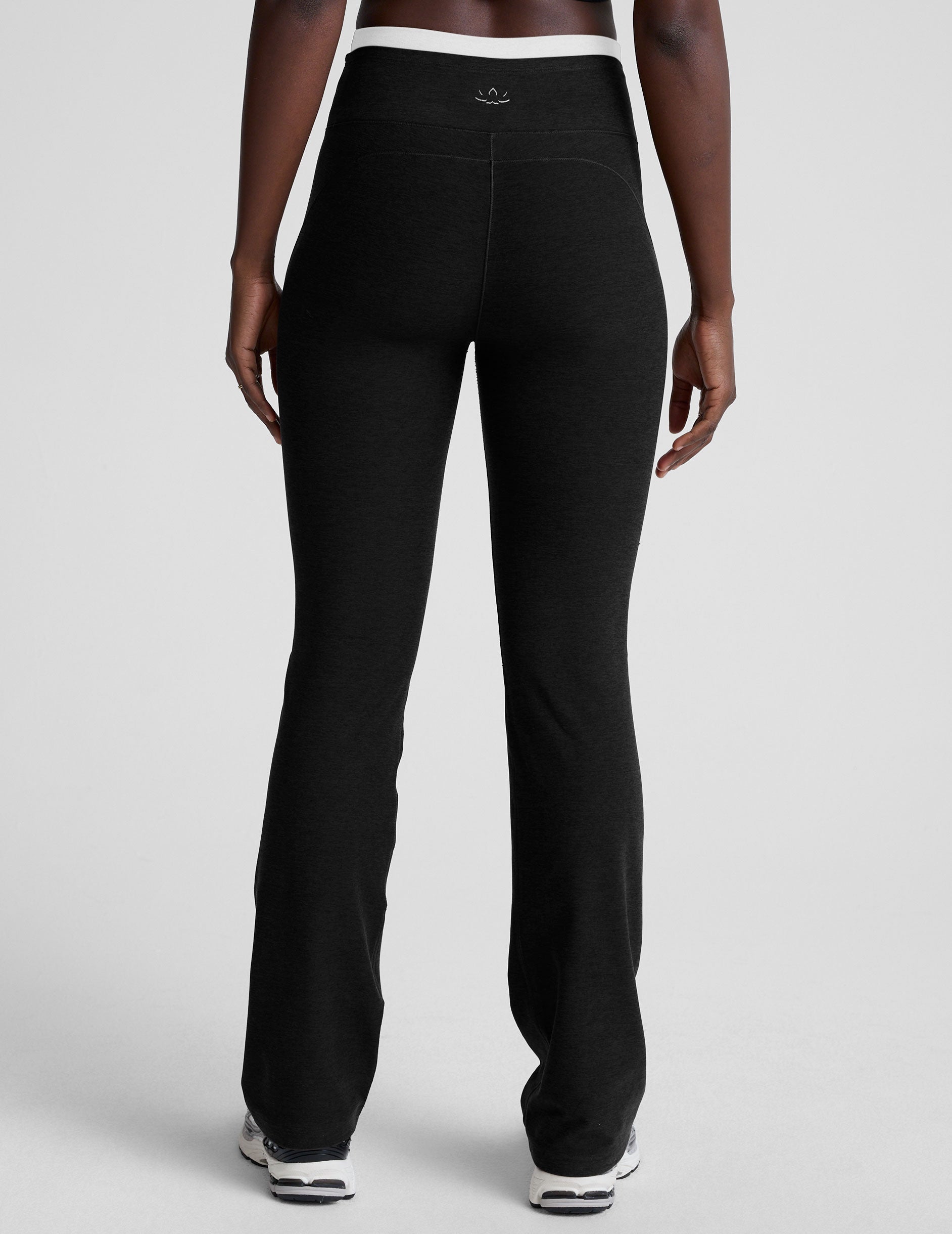 Rear view of black Spacedye Layered Bootcut Pant with a white contrast high waistband and full-length bootcut legs.