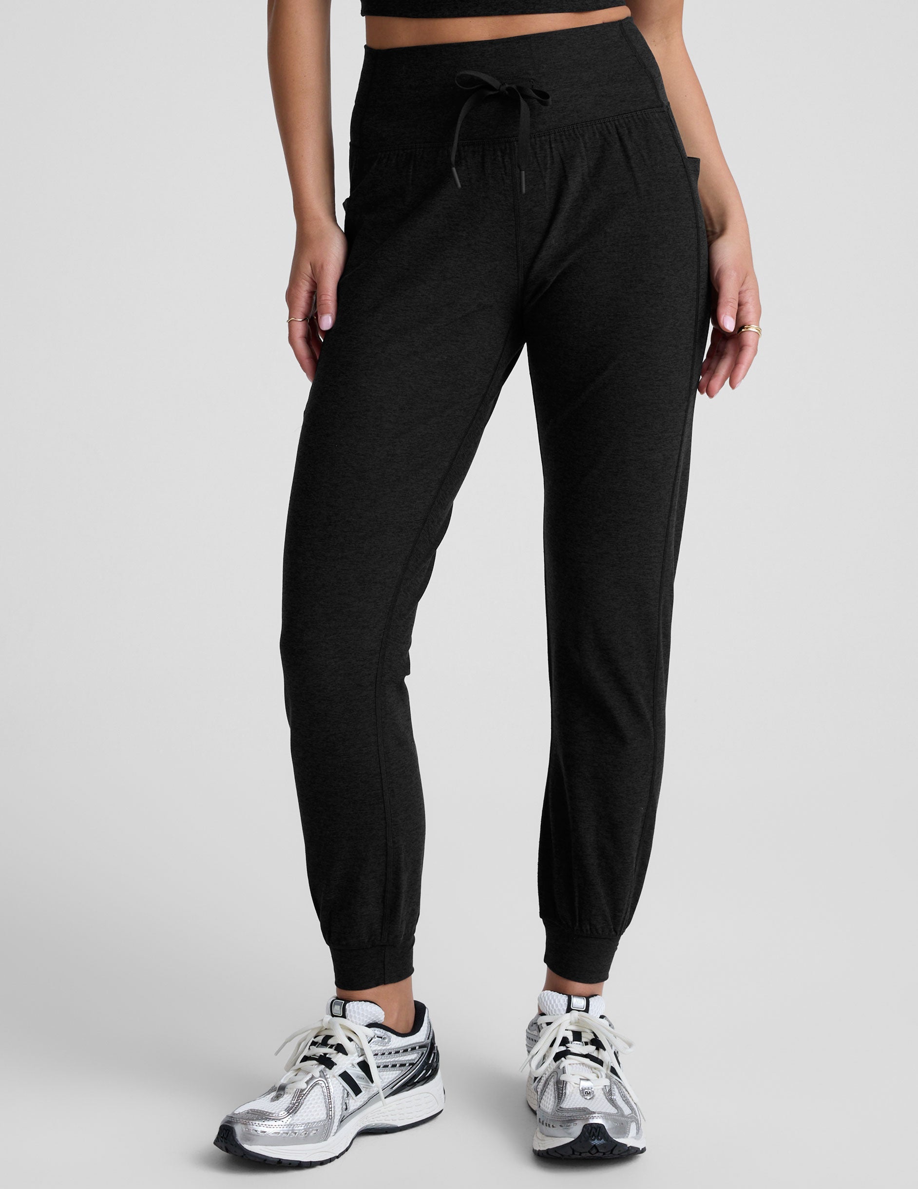 Model wearing Spacedye Go Pocket Jogger in black with a high drawstring waist, side pockets, and tapered cuffed ankles.