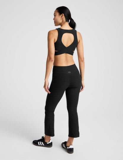 Rear view of black Spacedye Pintuck Kick Flare High Waisted Pant on a model, featuring a snug fit and cropped flared hem.