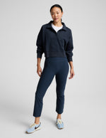Navy Spacedye Pintuck Kick Flare High Waisted Pant featuring front pintuck seams and a cropped flare leg on a model.