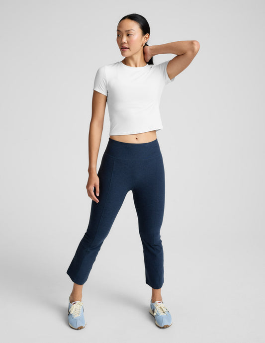 Model in navy Spacedye Pintuck Kick Flare High Waisted Pant with a high-rise waistband, pintuck seam, and cropped flare leg.