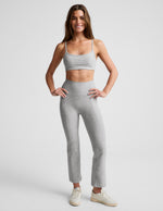 Woman wearing gray marled Spacedye Pintuck Kick Flare High Waisted Pant with front pintuck seams and cropped flared hem.