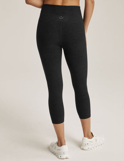 Back view of black Spacedye Walk And Talk High Waisted Capri Legging showing the marled fabric, high waist, and calf length.