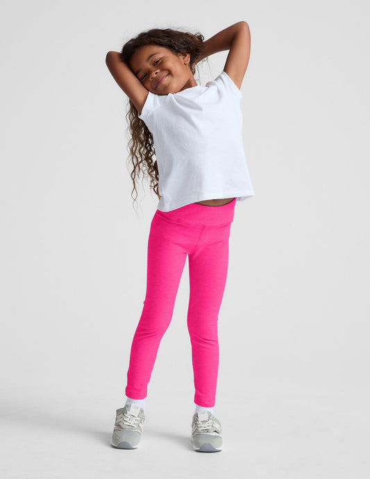 Smiling girl wearing fuchsia marled Spacedye Toddler Legging with a high waistband and snug, full-length fit.