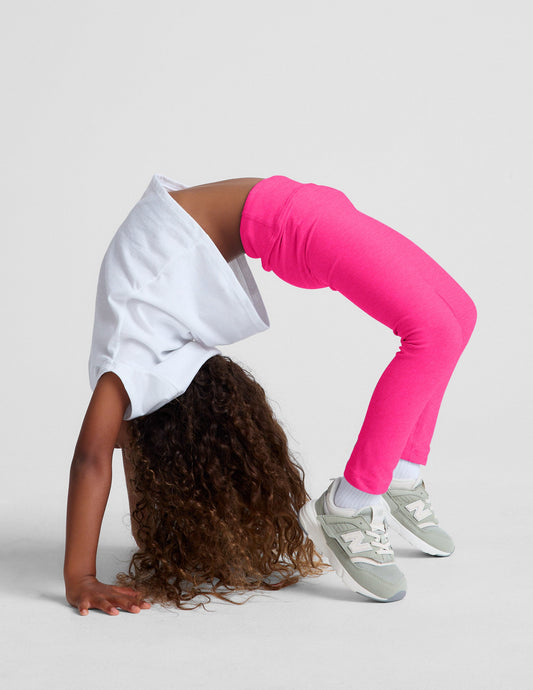 Fuchsia Spacedye Toddler Legging shown on a child in a backbend, highlighting the stretchy, full-length, marled fabric.