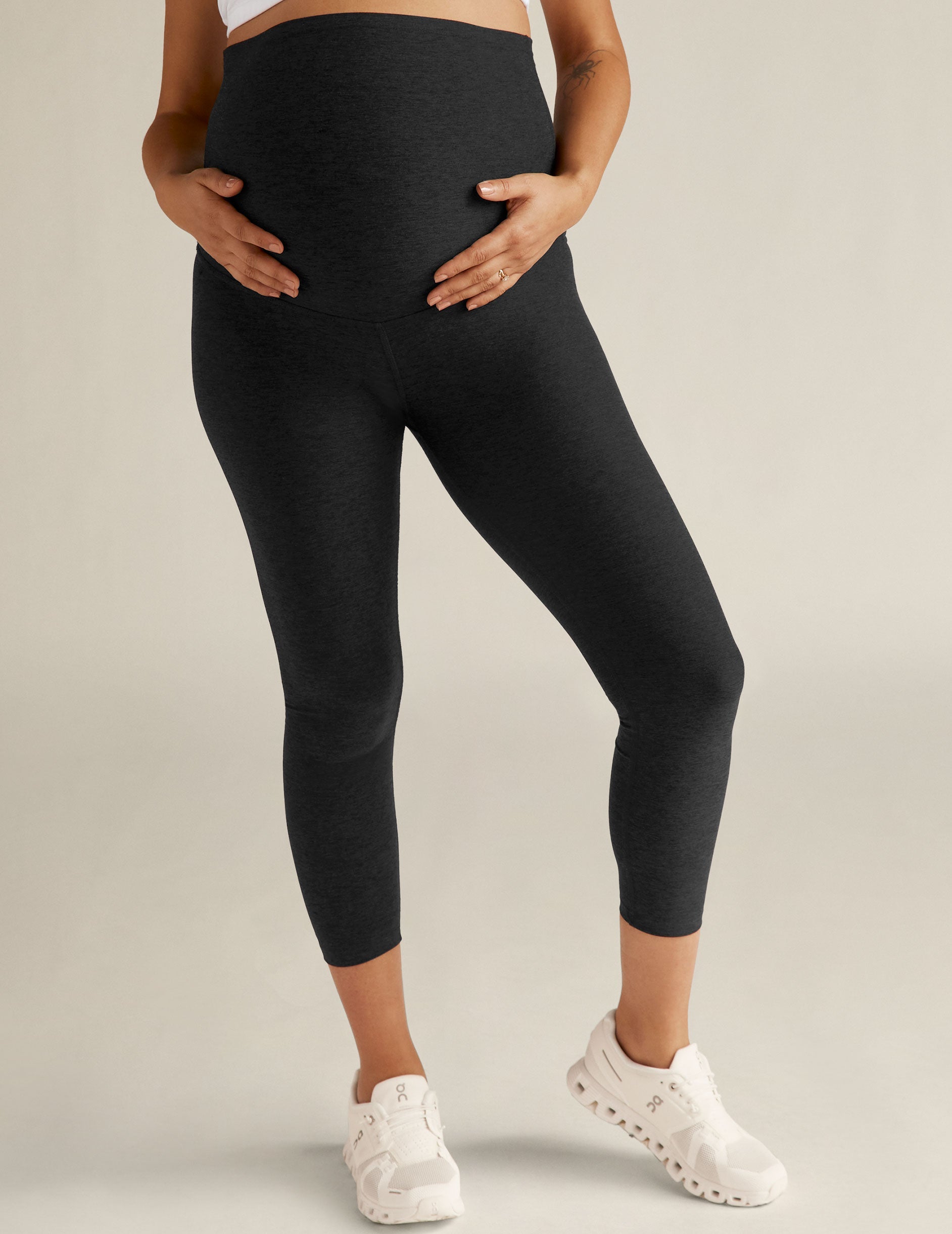 Spacedye Love The Bump Capri Maternity Legging in dark marled fabric with an over-the-belly waistband on a pregnant model.