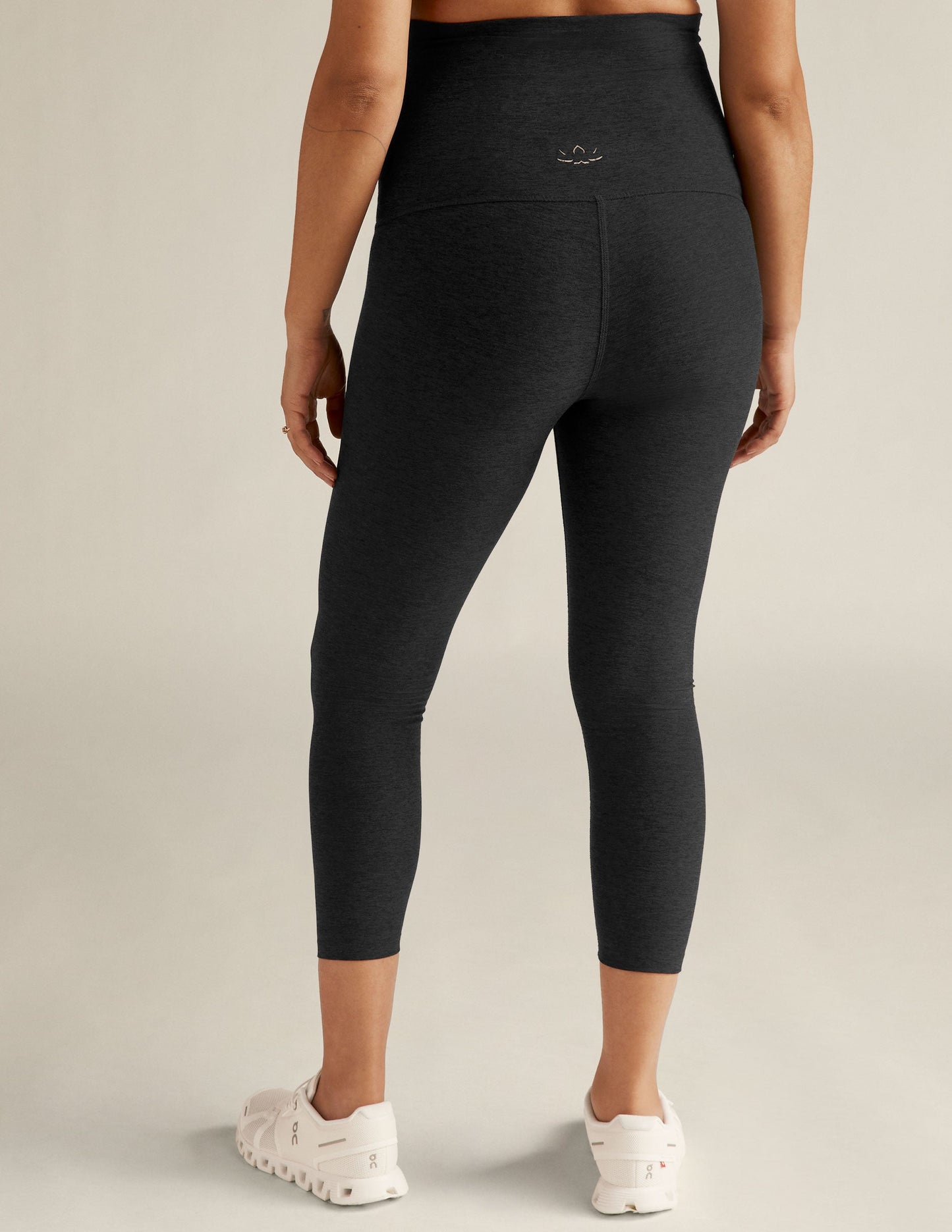 Back view of Spacedye Love The Bump Capri Maternity Legging in black marled fabric with a high waistband.