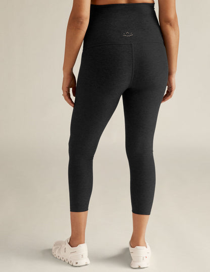 Back view of Spacedye Love The Bump Capri Maternity Legging in black marled fabric with a high waistband.