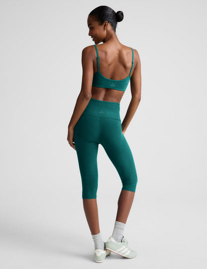Smiling model in teal Spacedye Pedal Pusher High Waisted Legging; rear view showing marled fabric and snug below-knee fit