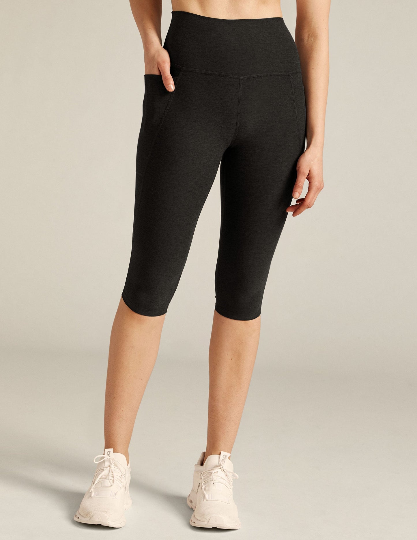 Black marled Spacedye High Waisted Pocket Pedal Pusher Legging on a model with a hand in the side pocket.