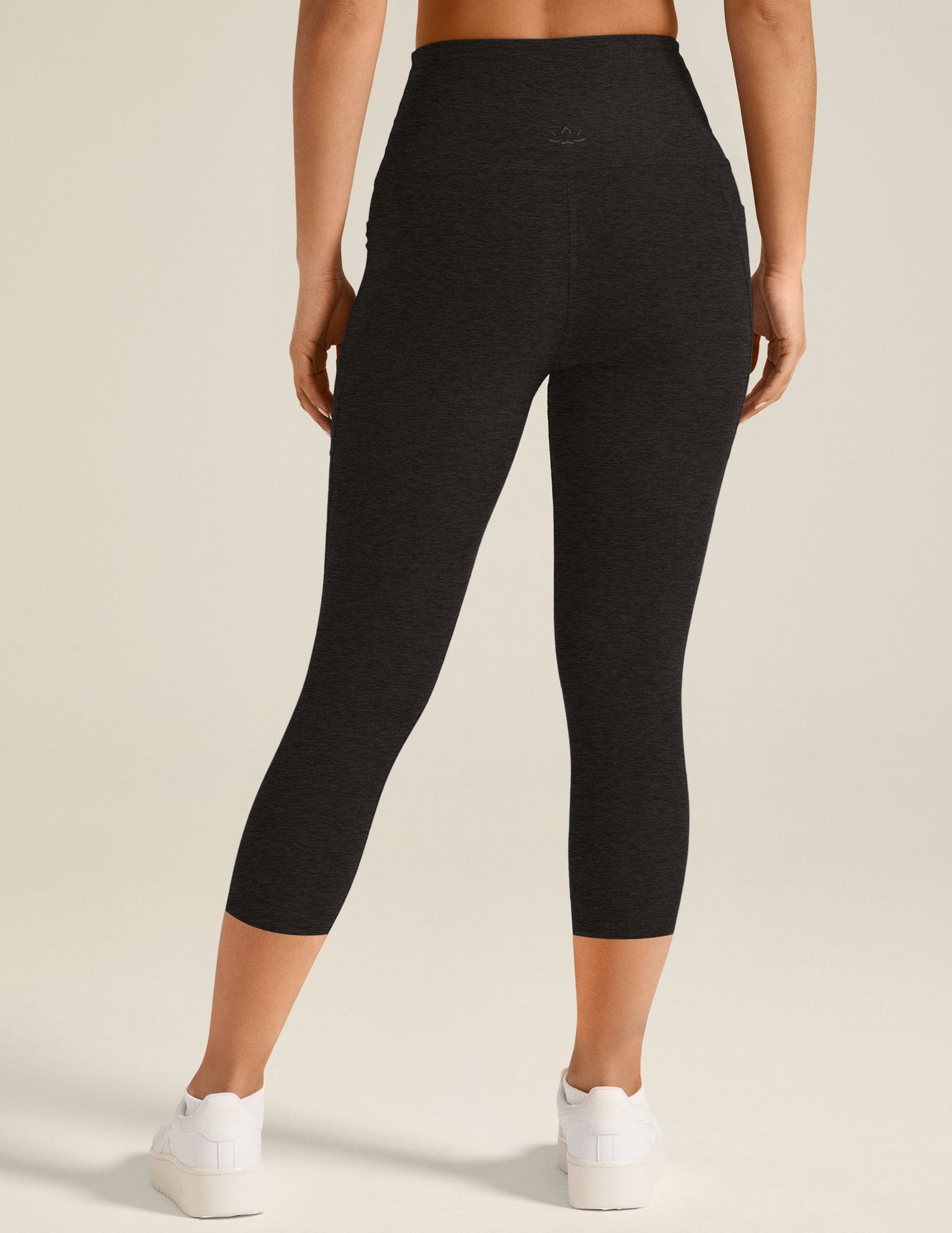 Back view of marled black Spacedye Out Of Pocket High Waisted Capri Legging with side pockets and a wide waistband.
