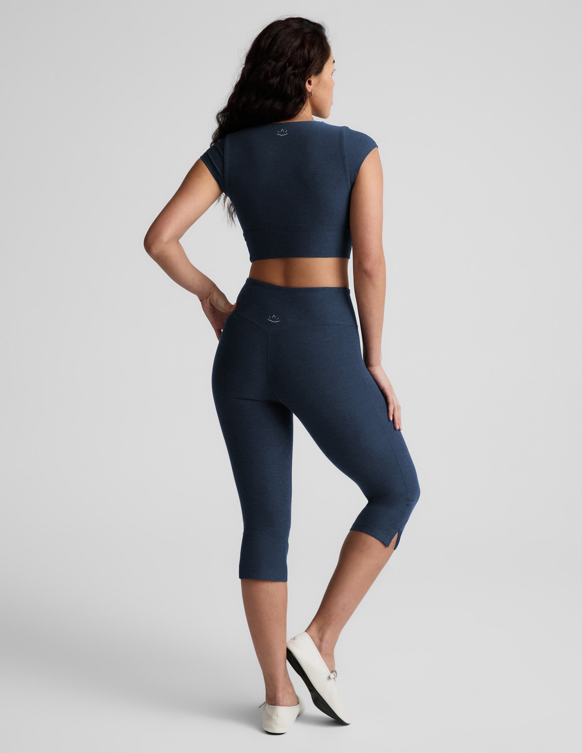 Navy Spacedye Mid-Rise Slit Pedal Pusher Legging on a model from behind, showing the calf length and small side slits.