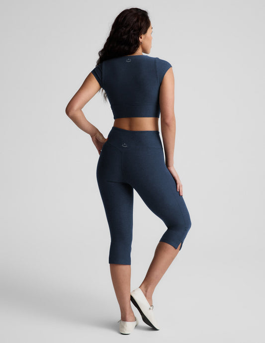 Navy Spacedye Mid-Rise Slit Pedal Pusher Legging on a model from behind, showing the calf length and small side slits.