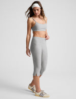 Gray marled Spacedye Mid-Rise Slit Pedal Pusher Legging with side slits at the hem and wide waistband shown on a model.