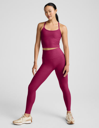 Woman wearing a red athletic outfit on a light gray background.
