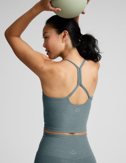 Woman wearing a gray athletic outfit on a white background