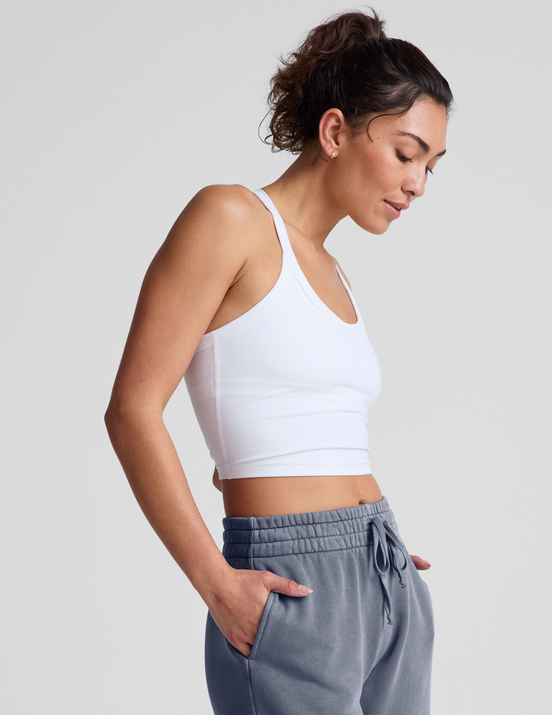 white cropped tank top with a v neckline and high racerback.