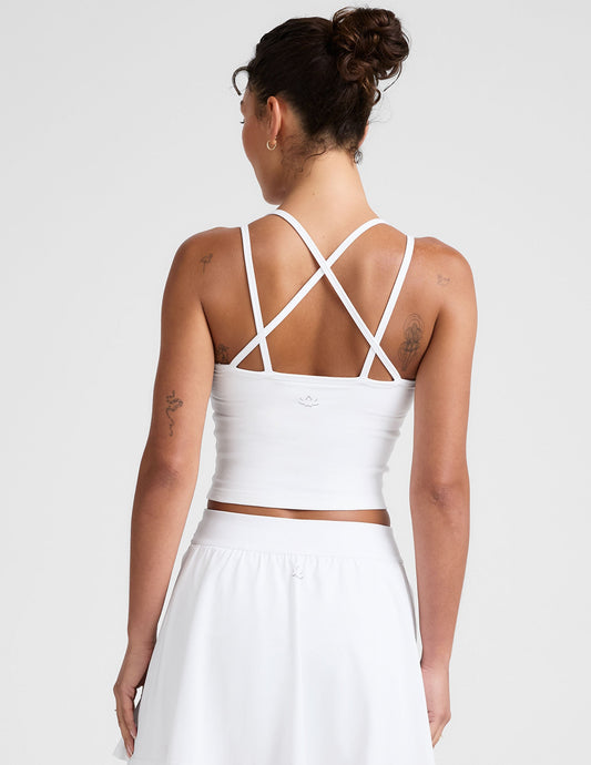 white waist length, V neckline​ tank top with a self shelf bra and criss-cross strap back detail​.
