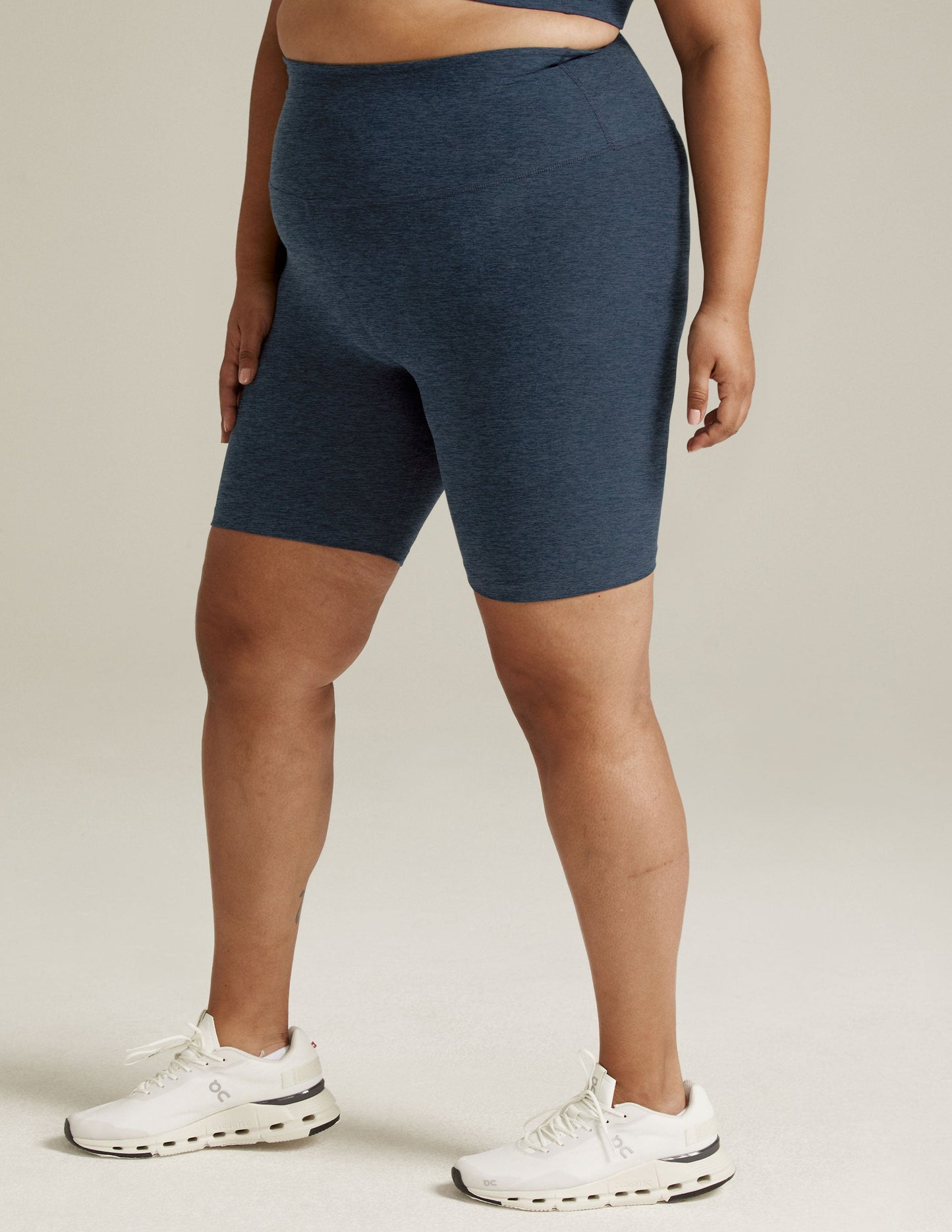 Nocturnal navy marled Spacedye High Waisted 7" Biker Short with a mid-thigh length on a standing model.