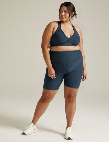 Woman wearing Spacedye High Waisted 7" Biker Short in Nocturnal Navy marled fabric with a matching sports bra.