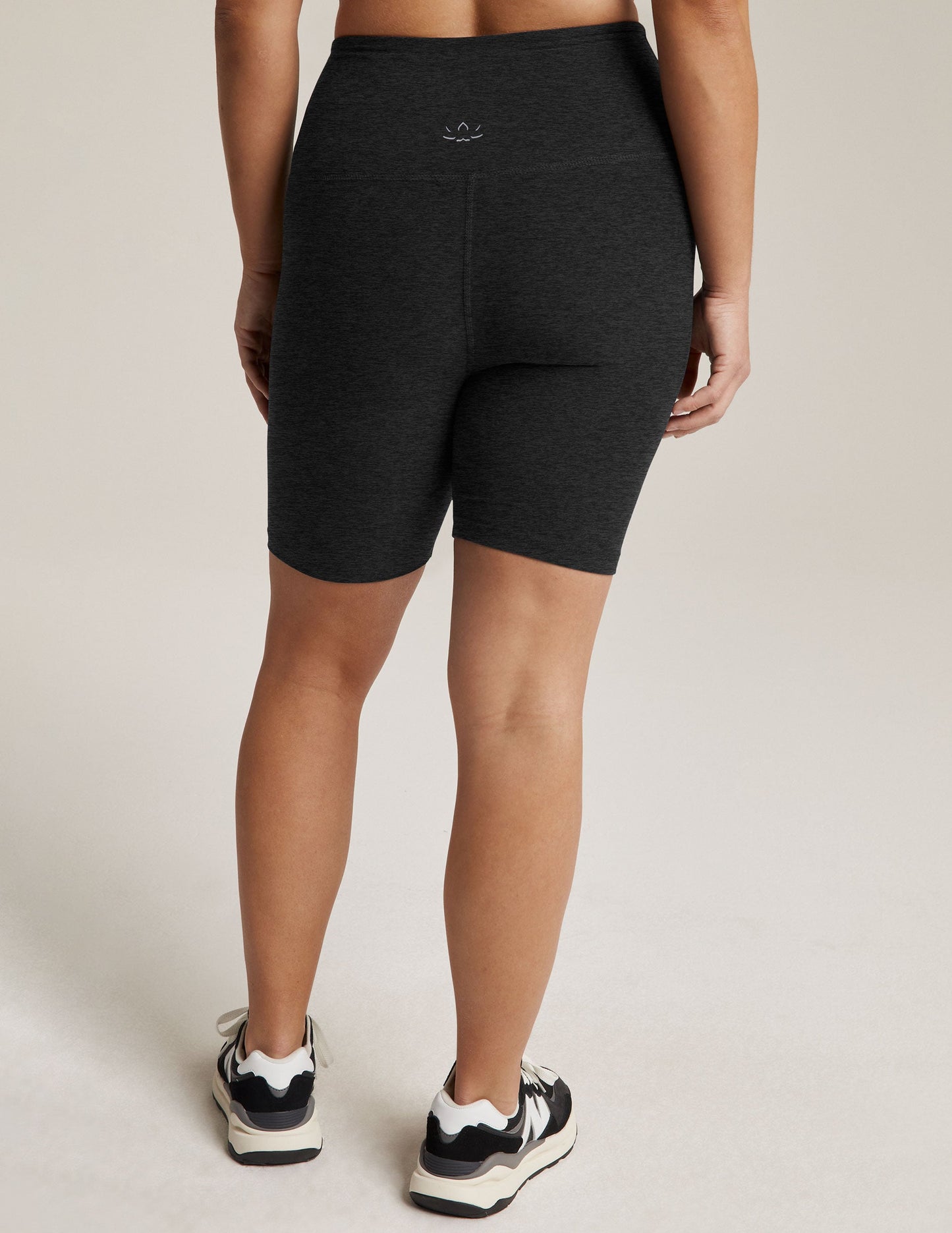 Rear view of Spacedye High Waisted 7" Biker Short in marled black, hitting mid-thigh with a high waistband and small logo.