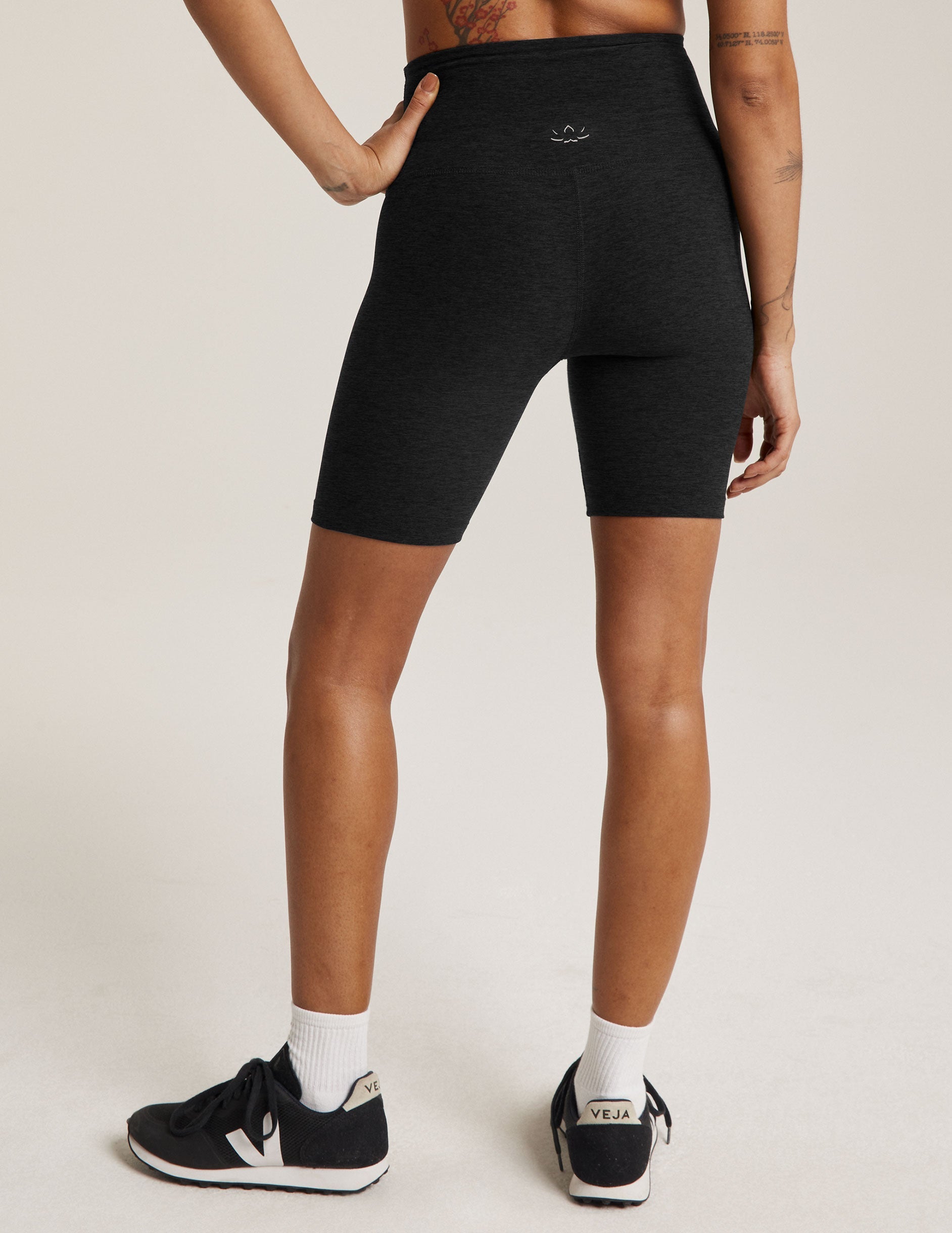 Rear view of Spacedye High Waisted 7" Biker Short in black marled fabric, featuring a high rise and mid-thigh length.