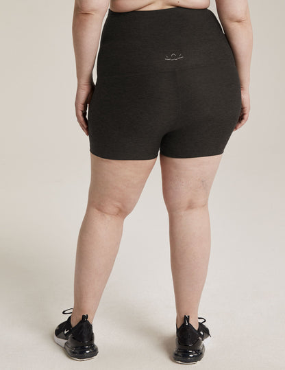 Woman wearing Gray Spacedye™ All For Run Maternity Short from the rear view paired with black sneakers.