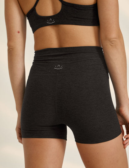 Rear view of high-waisted Spacedye All For Run 3" Short in marled Darkest Night black with a snug, athletic fit.