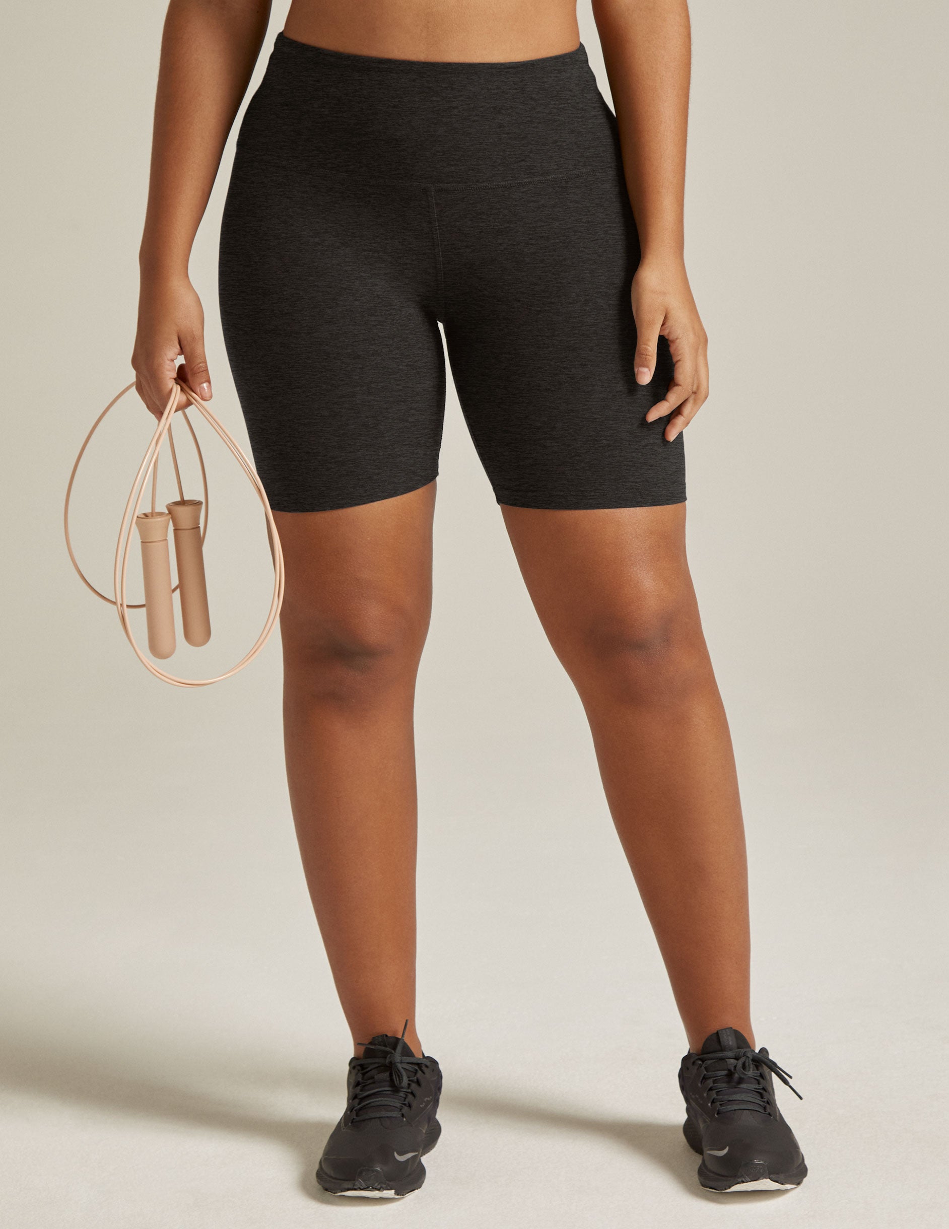 Woman wearing Gray marled Spacedye Keep Pace 5" Biker Short™ paired with a jump rope and black sneakers.