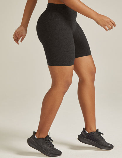 Side profile of woman wearing Darkest Night Spacedye Keep Pace 5" Biker Short™ paired with black sneakers.