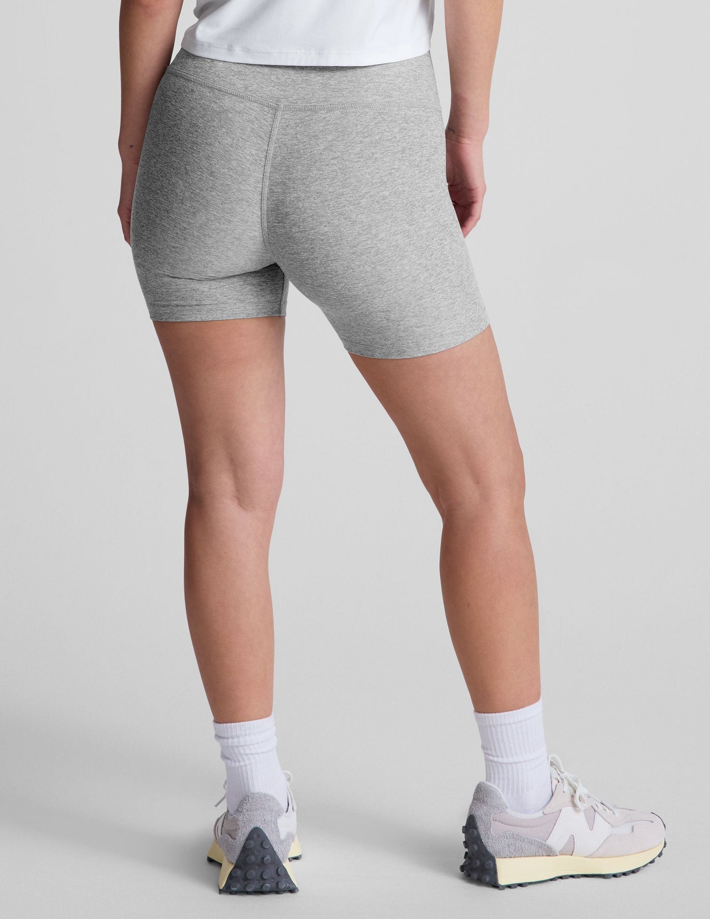 Rear view of a model in the gray marled Spacedye Keep Pace 5" Short, featuring a high waist and snug mid-thigh fit.