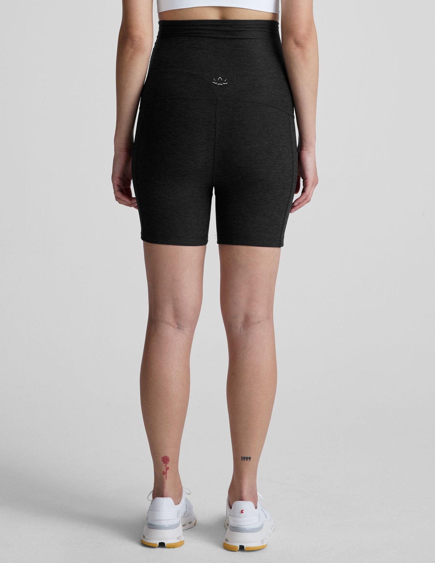 Back view of black marled Spacedye Keep Pace 5" Maternity Pocket Biker Short with high-rise waist and snug mid-thigh fit.