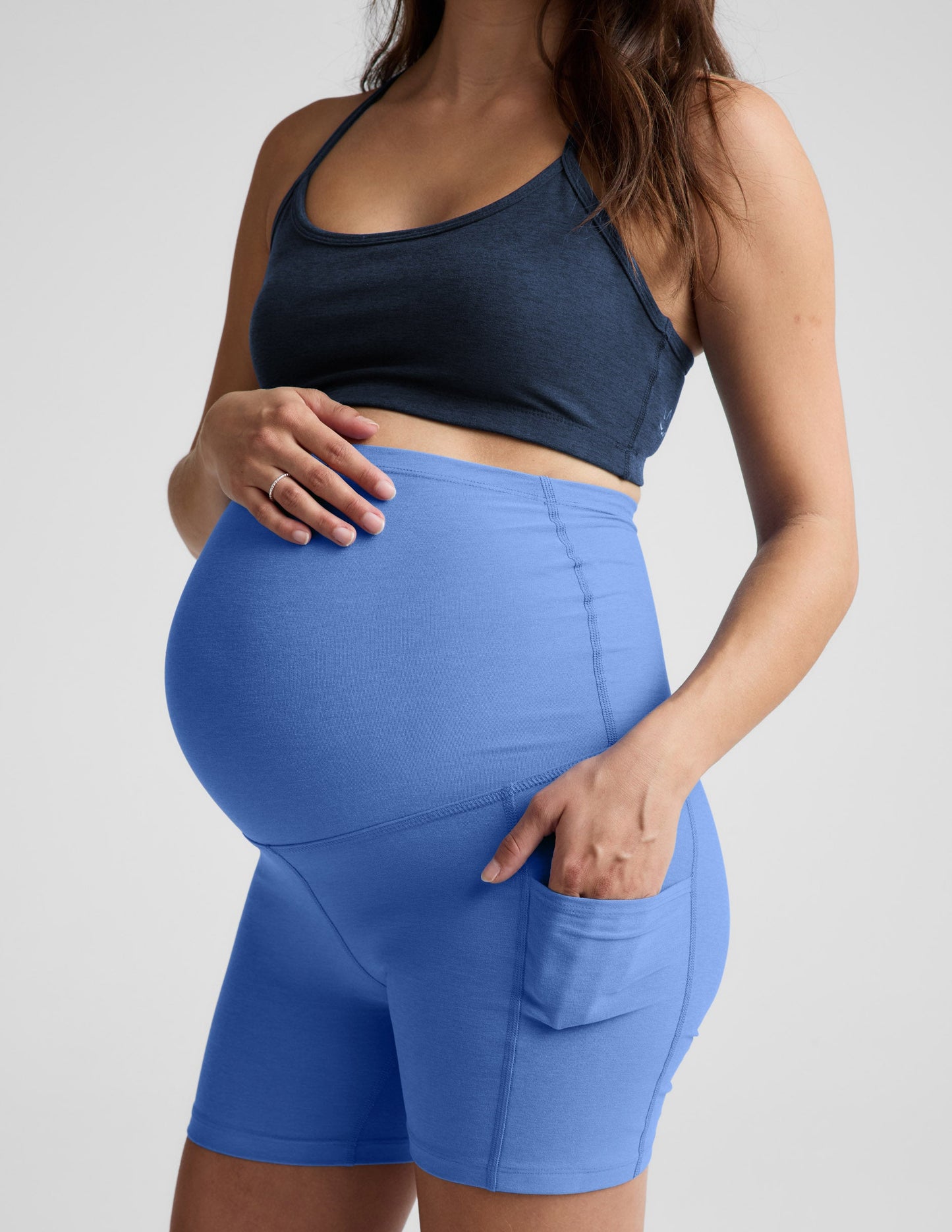 Blue Spacedye Keep Pace 5" Maternity Pocket Biker Short in blue with a high waistband over the bump and side pockets.