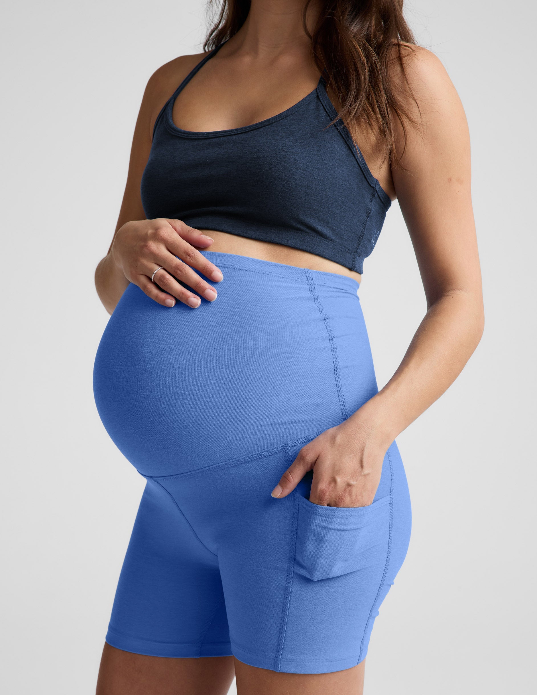 Blue Spacedye Keep Pace 5" Maternity Pocket Biker Short in blue with a high waistband over the bump and side pockets.