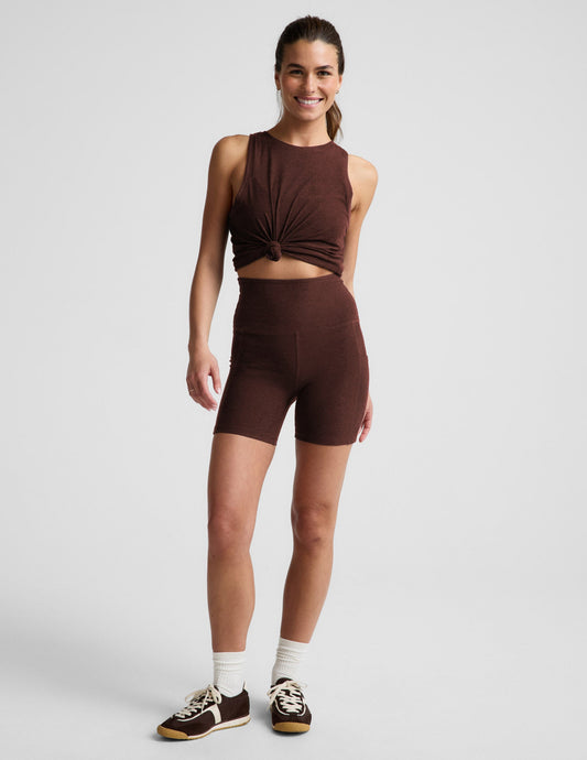 Woman wearing Brown Spacedye™ Keep Pace 5" Pocket Short with side pockets, paired with a matching knotted tank top.