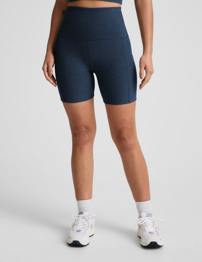 Person wearing navy blue athletic shorts on a light gray background.