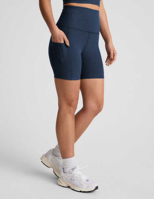 Person wearing navy blue athletic shorts on a light gray background.