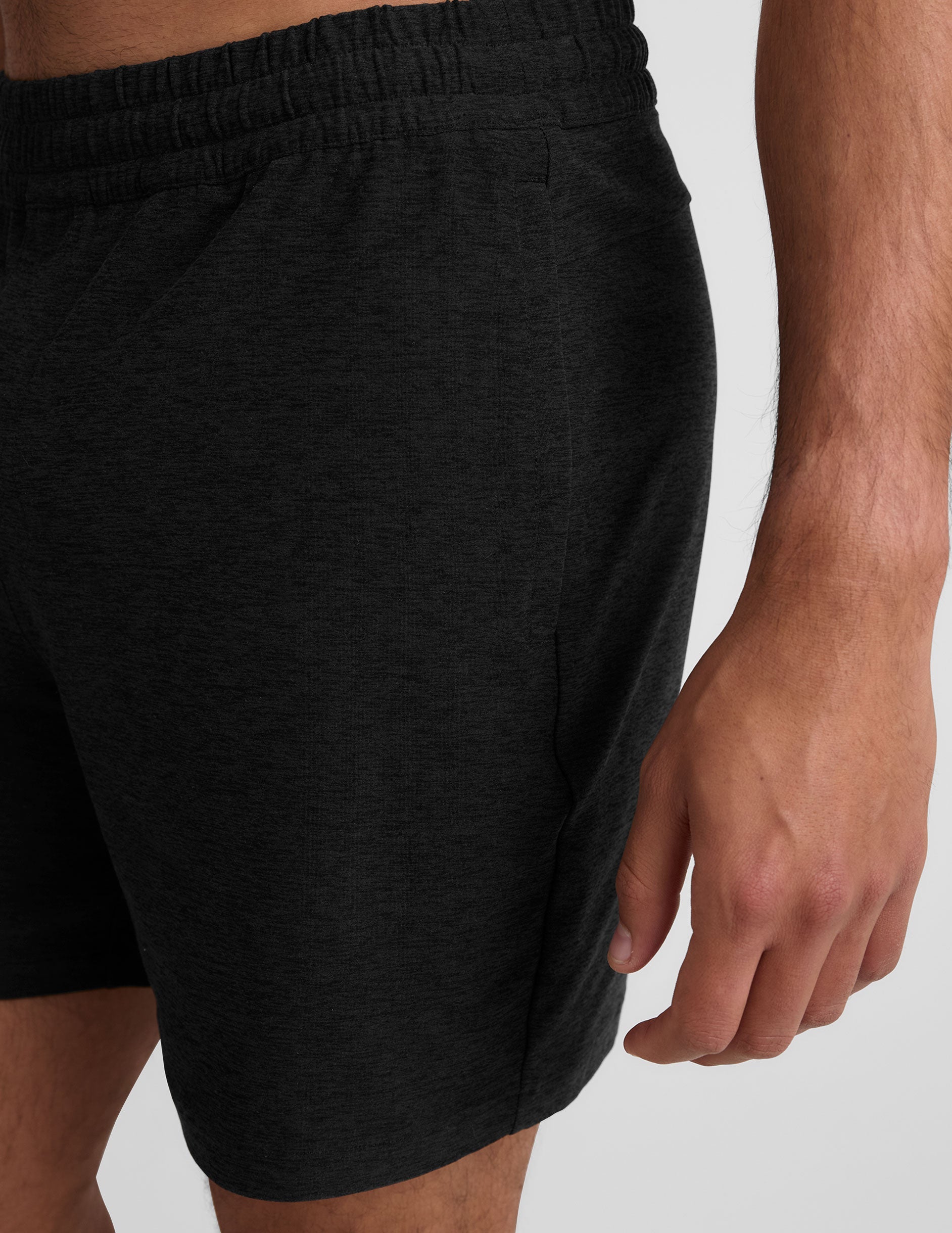 Side view of black marled Spacedye Unlimited Men's Short showing the elastic waistband and side pocket on a relaxed fit.