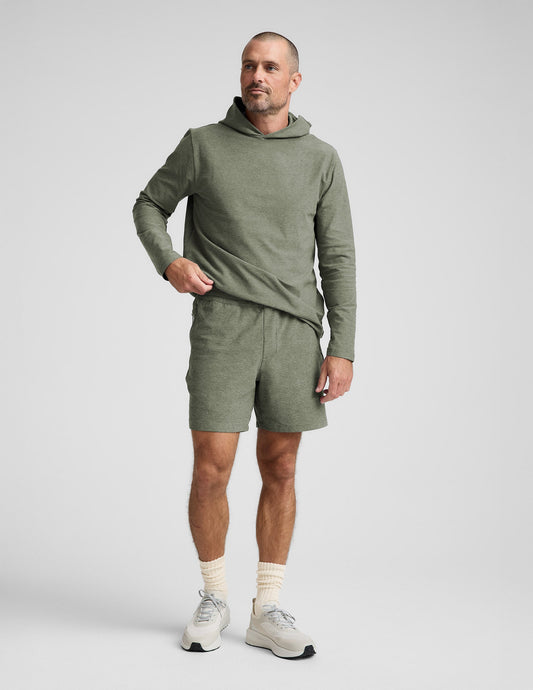 Man wearing Olive Spacedye Unlimited™ Men's Short paired with a matching hoodie, white socks, and cream sneakers.