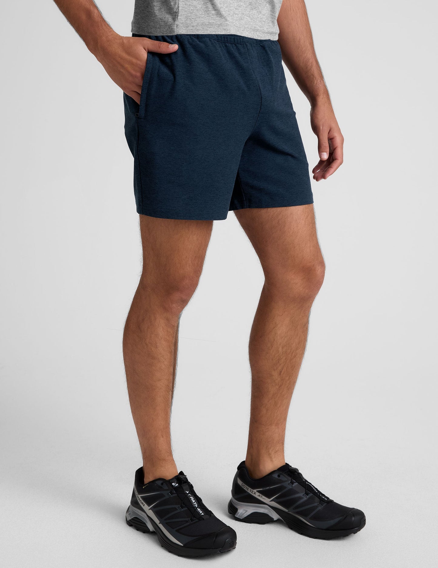 Navy marled Spacedye Unlimited Men's Short with an elastic waistband and relaxed 7" inseam, shown on a model.