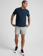 Light gray marled Spacedye Unlimited Men's Short with a 7" inseam and relaxed fit, styled with a navy t-shirt.