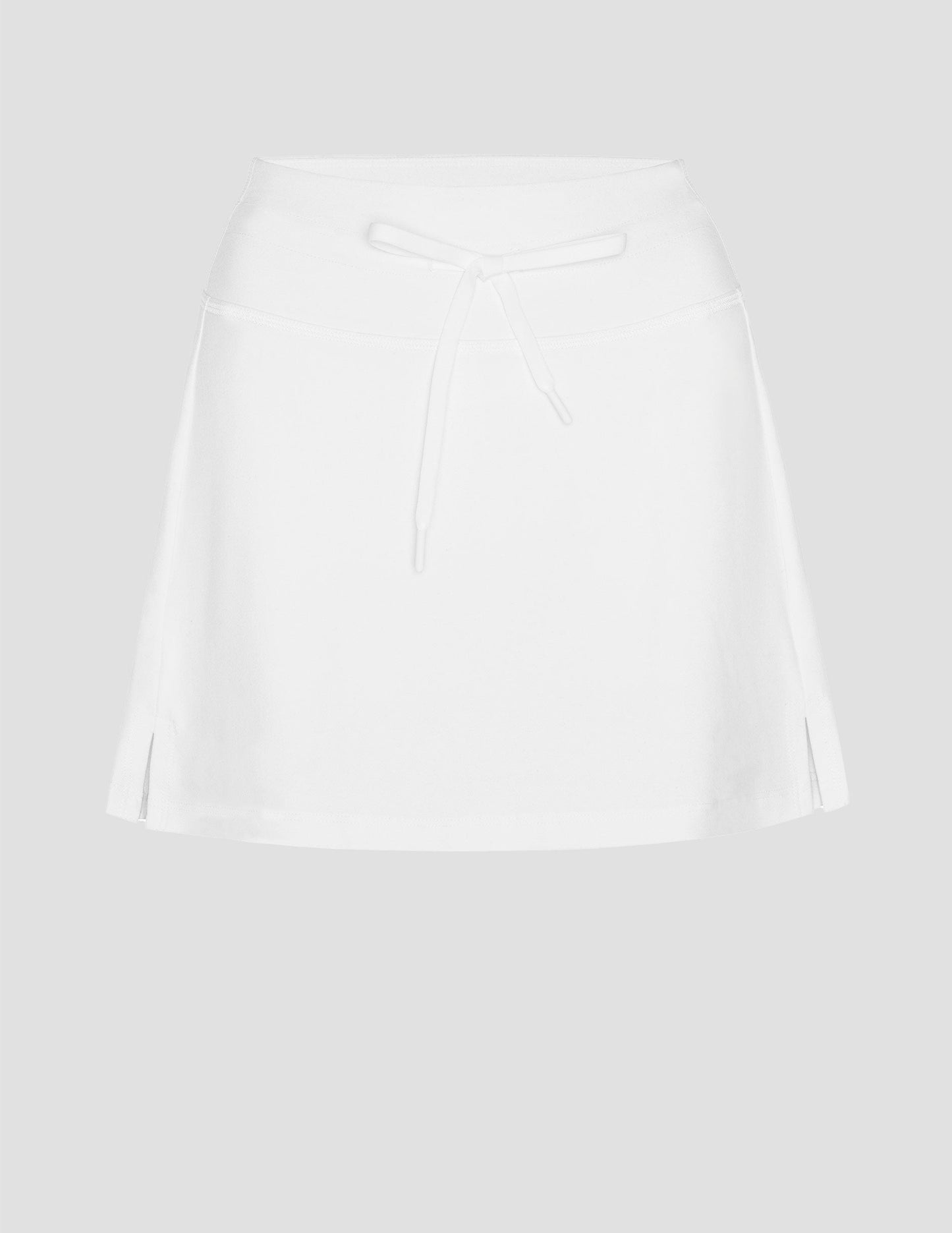 white mini skirt with a drawstring at waistband and built in shorts with pockets.